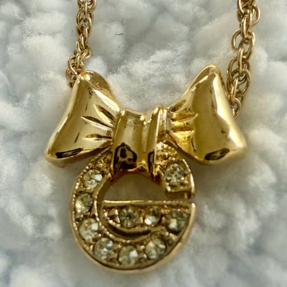 Givenchy “G” rhinestone Gold Bow Pendant Necklace. Perfect condition.